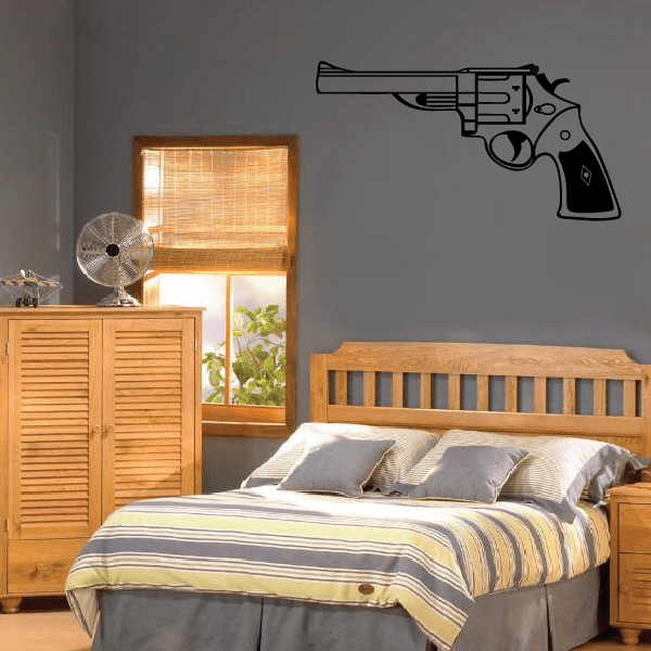 Revolver wall decal of a dark gray revolver pistol silhouette on wall