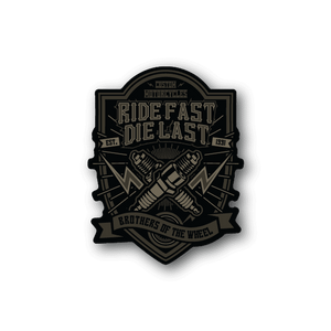 Vinyl sticker, black and gold motorcycle crest: “Ride Fast Die Last”.