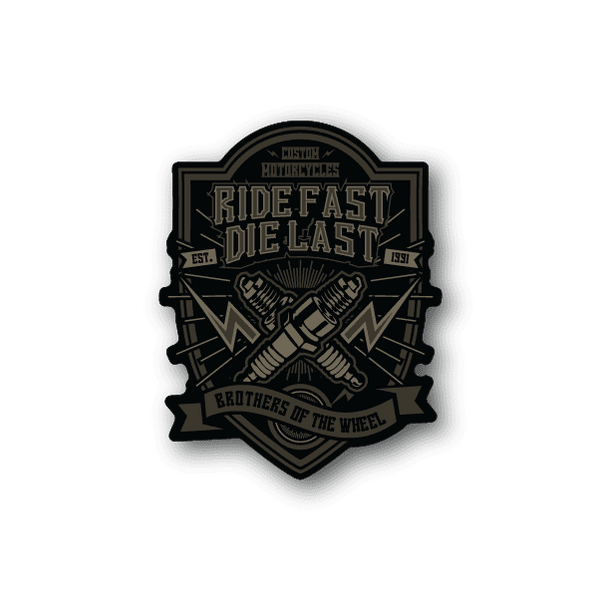Vinyl sticker, black and gold motorcycle crest: “Ride Fast Die Last”.