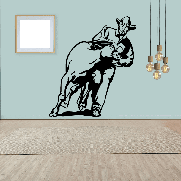 Wall adhesive depicting the thrill of a cowboy in a bull-riding event