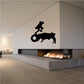 Wall graphic of a bull charging at a cowboy but hits a tire instead decal