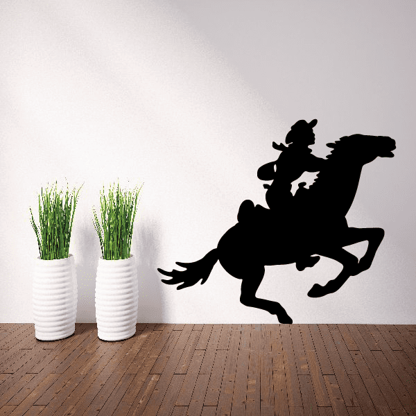 Wall adornment featuring a cowboy atop a horse in mid-gallop