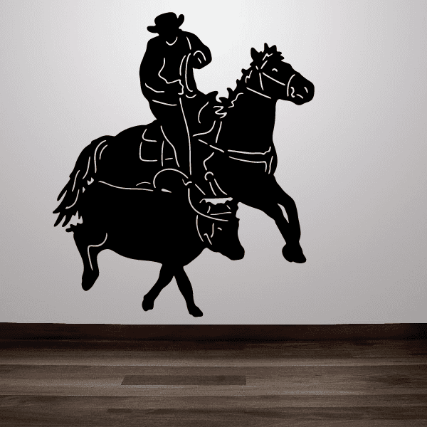 Rodeo-inspired wall decal showing a cowboy atop a horse leading a cow