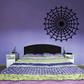 Round spider web wall decal with black and purple web pattern