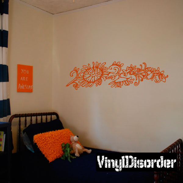 Wall decal with orange ornate floral scroll across a wall