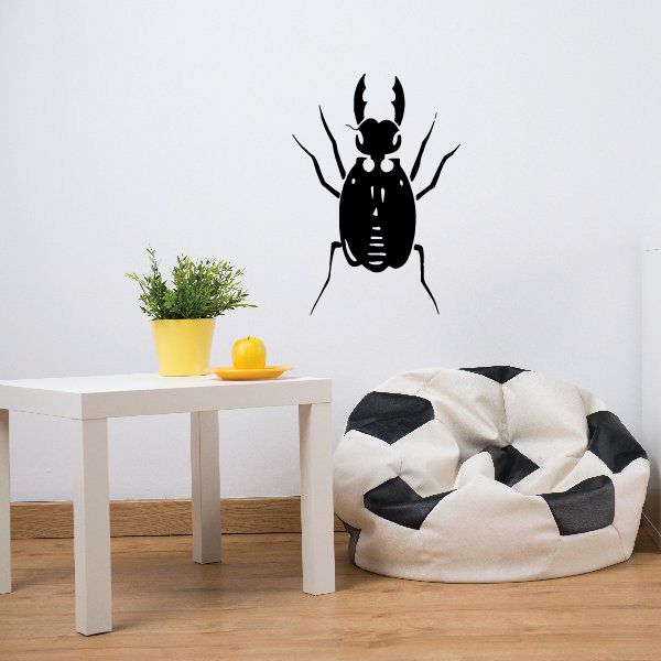 Black scarab beetle wall decal with horned silhouette and antennae