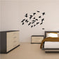 Duck flock wall decal with scattered black ducks in flight pattern