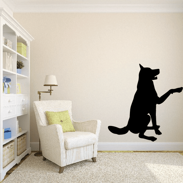 Sitting wolf silhouette wall decal with one paw raised, black graphic