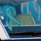Light blue awareness ribbon vinyl sticker with white cursive text on car window