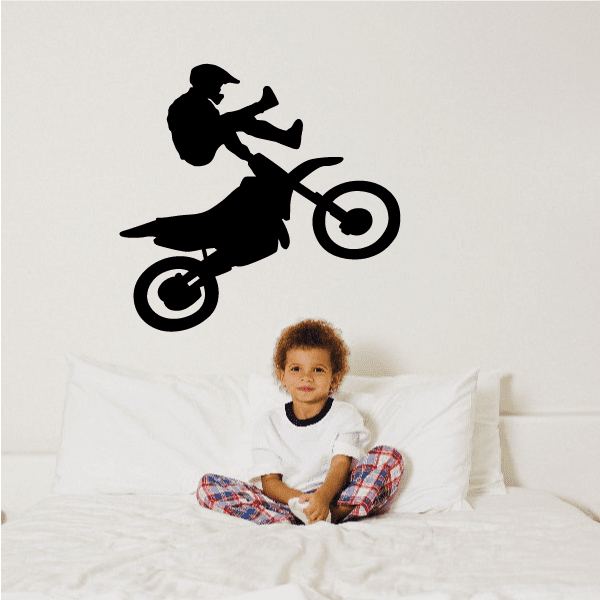 Black dirt bike rider silhouette decal with spinning wheels and motion lines