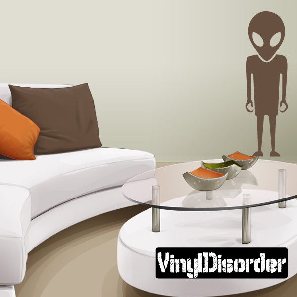Alien decal with simple brown standing figure and white oval eyes