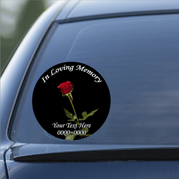 Circular memorial sticker with red rose and white script text on black background