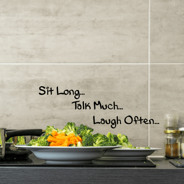 Wall decal text: “Sit Long… Talk Much… Laugh Often…”