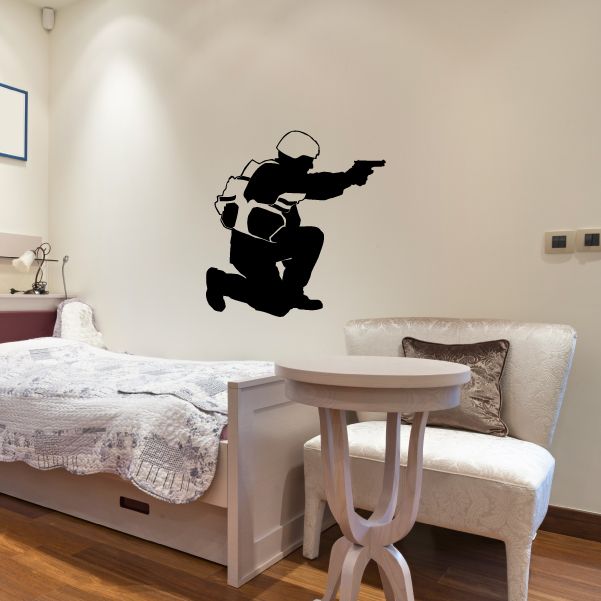 Sitting armored soldier wall decal with handgun design