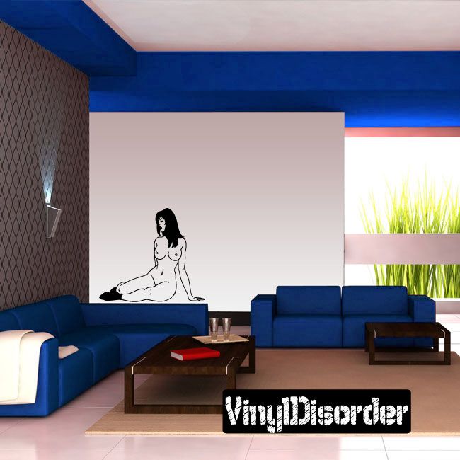 Vinyl wall decal of a nude woman sitting with socks on a wall
