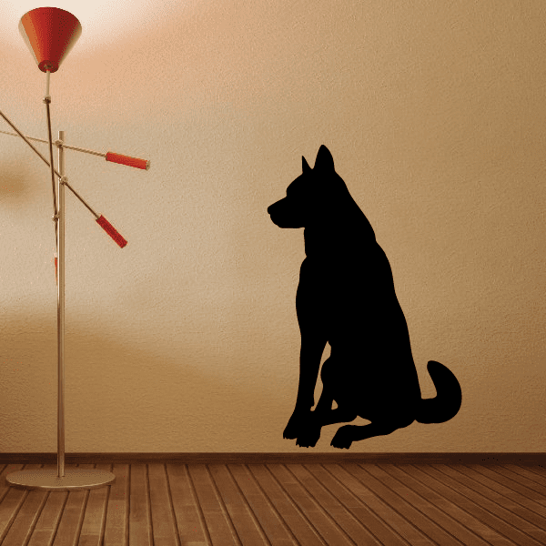 Seated obedient dog decal in black, side profile silhouette with curled tail