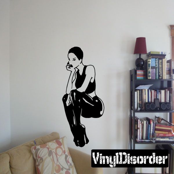 Sitting woman vinyl decal in black latex pants and heels, posed with hand to chin