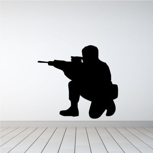 Sitting soldier shooting decal, black silhouette of a seated soldier aiming a rifle