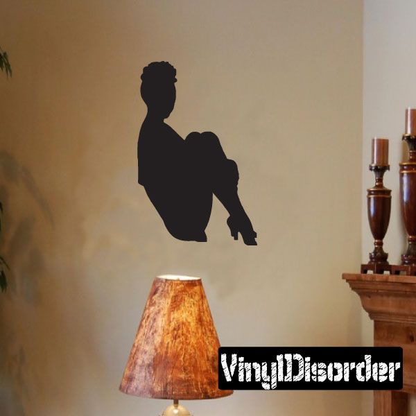 Seated woman silhouette wall decal holding legs, black