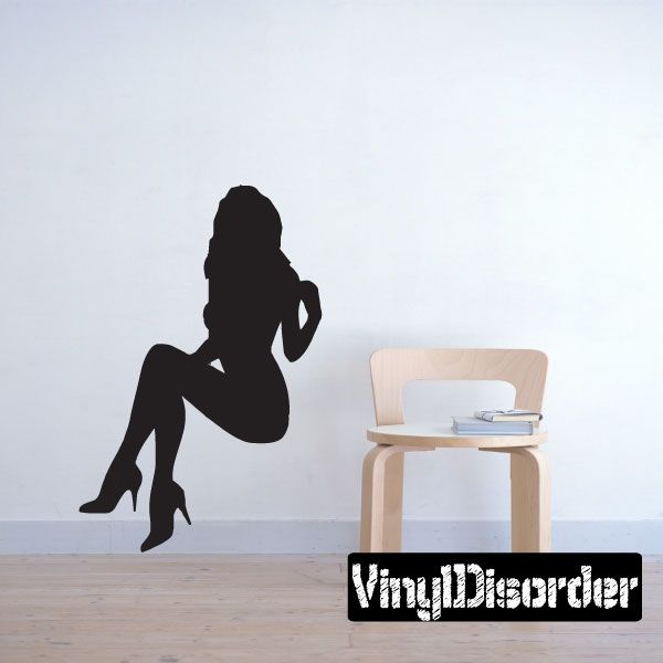 Black silhouette decal of a seated woman in high heels