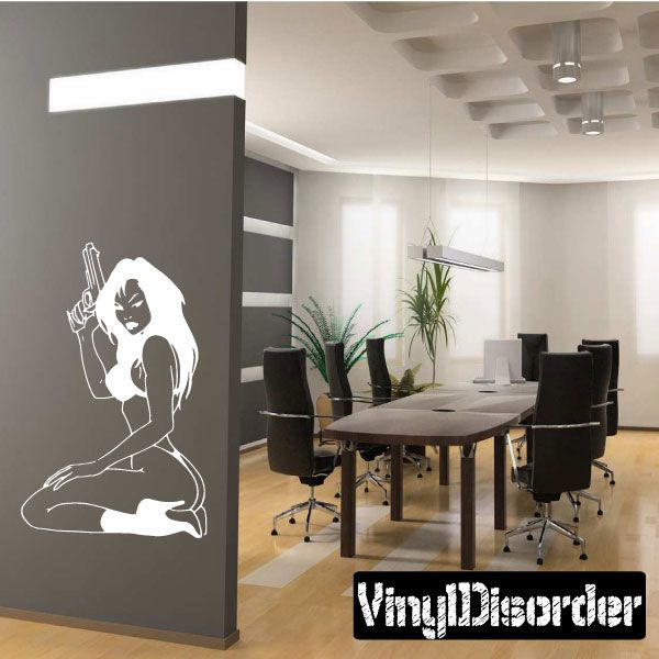 White wall decal of seated woman holding a gun, simple line art silhouette