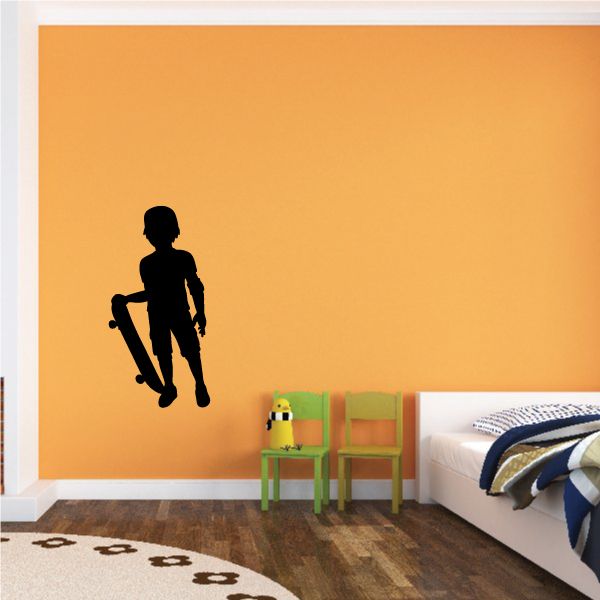Skateboarding boy wall decal, black silhouette holding a skateboard