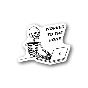 Vinyl laptop sticker: cartoon skeleton typing with 'worked to the bone' lettering