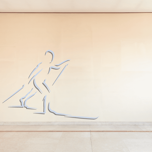 Skiing wall decal vinyl sticker showing a blue skier mid-action with skis