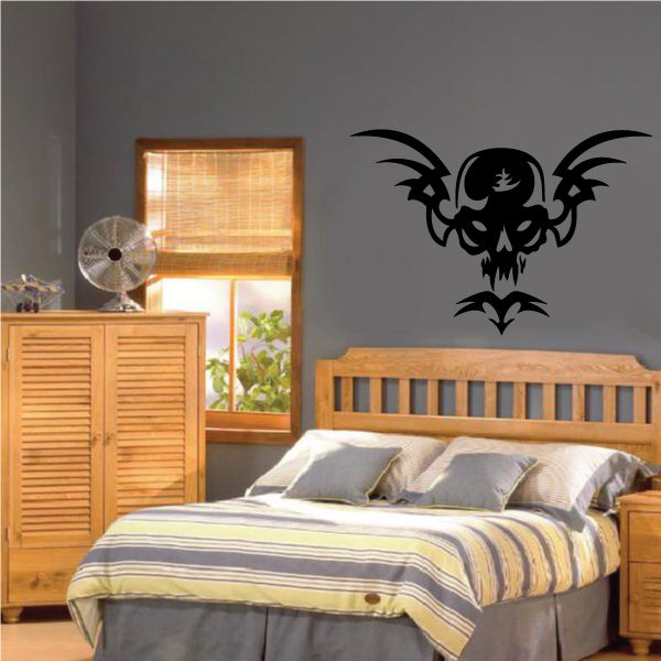 Black skull tribal wall decal with winged flames and bat-like ornaments
