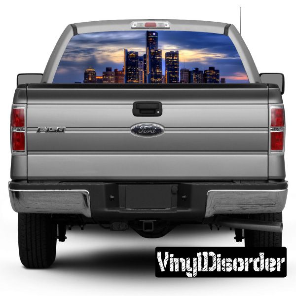Gray pickup truck rear window skyline graphic, Chicago-style city skyline scene