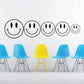 Smiley face family wall decal set with five black-outlined smiling faces