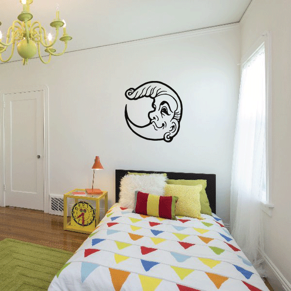 Moon face decal with smiling profile, black outline on wall