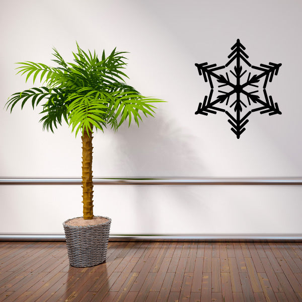 Tropical palm setting with a snowflake wall decal in the backdrop