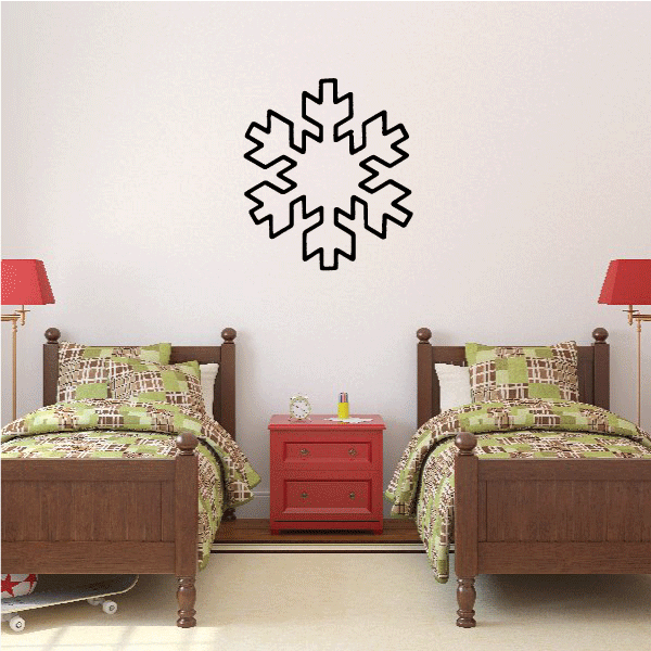 Twin beds in a bedroom complemented by snowflake wall decor