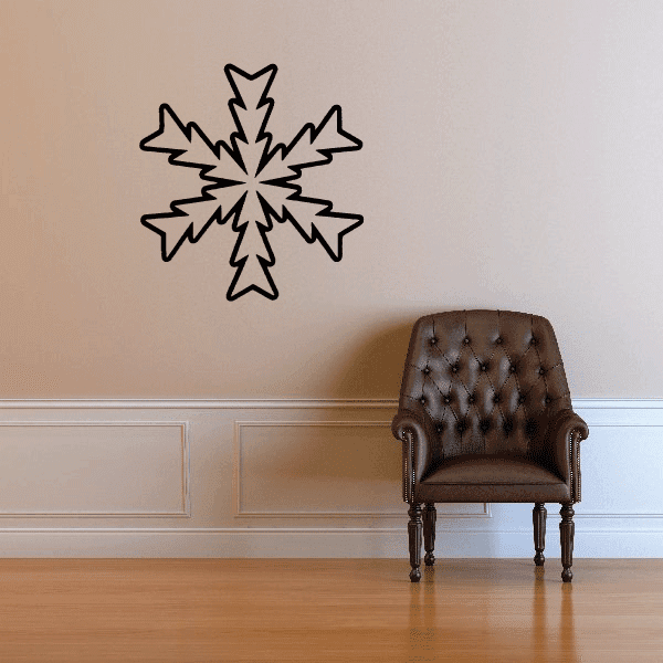 Single snowflake decal above a chair, adding a winter touch to the room