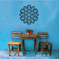 A set of snowflake decals displayed on a blue wall above a table and chairs