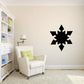 Living room featuring a bold black Snowflake Wall Decal as a focal point