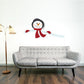 Cartoon snowman sticker, black and white with orange beak and red scarf