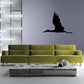Soaring stork wall decal in black, flying silhouette on a base line