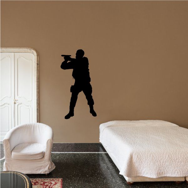 Soldier aiming handgun wall decal, black silhouette figure
