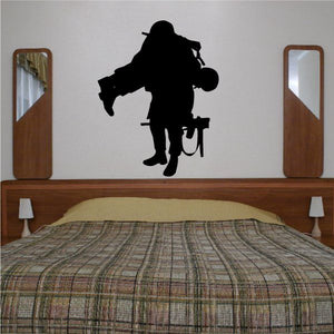 Black soldier decal carrying wounded soldier silhouette