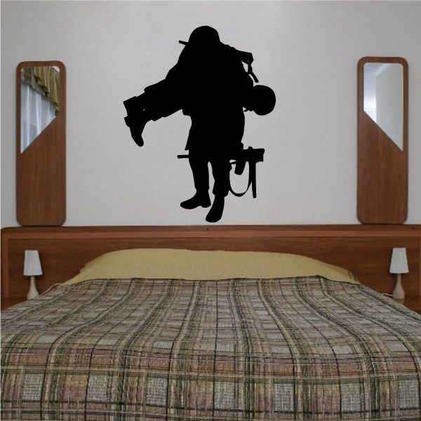 Black soldier decal carrying wounded soldier silhouette