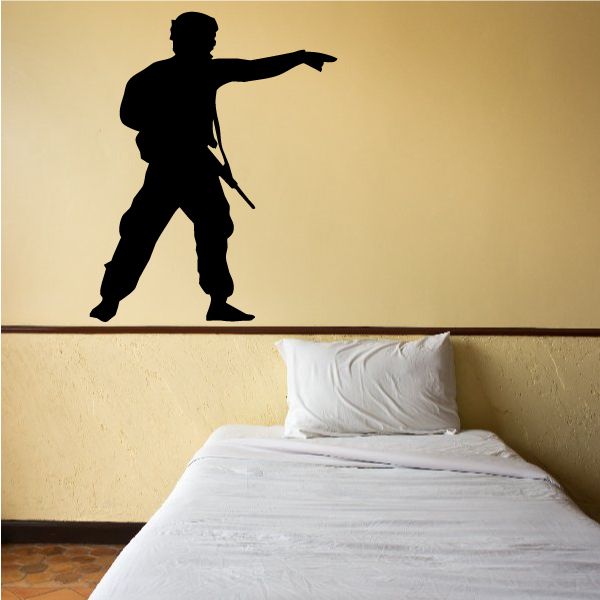 Soldier directing wall decal with black silhouette, one arm pointing right