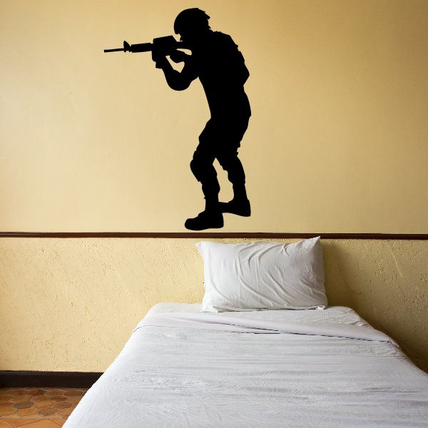 Soldier holding a rifle pointing wall decal, dark silhouette