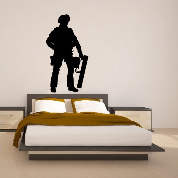 Wall decal of a soldier holding a mortar, black silhouette