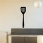 Black spatula wall decal with white handle detail