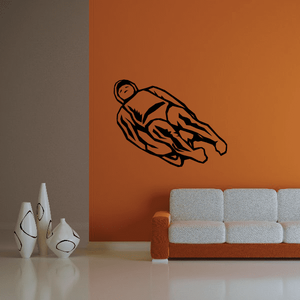 Cartoon lugeing decal of dark outline sledder in speeding pose