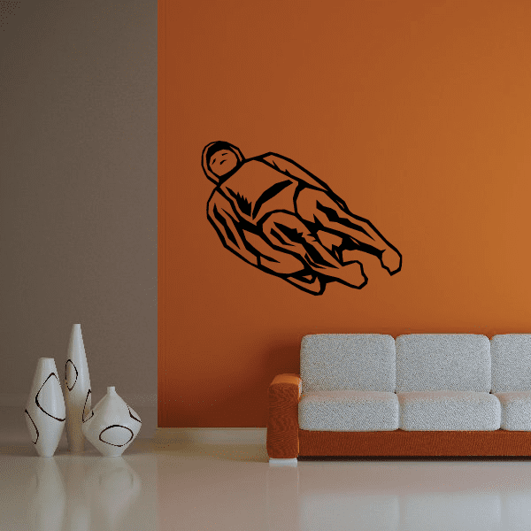 Cartoon lugeing decal of dark outline sledder in speeding pose