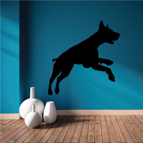 Black silhouette of sprinting Doberman Pinscher on a decal