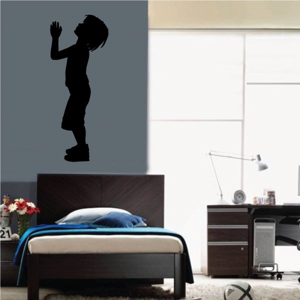 Black standing boy praying to the sky wall decal